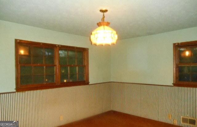 3296 Columbia Woods Dr, Decatur, GA 30032 - spare room with a chandelier