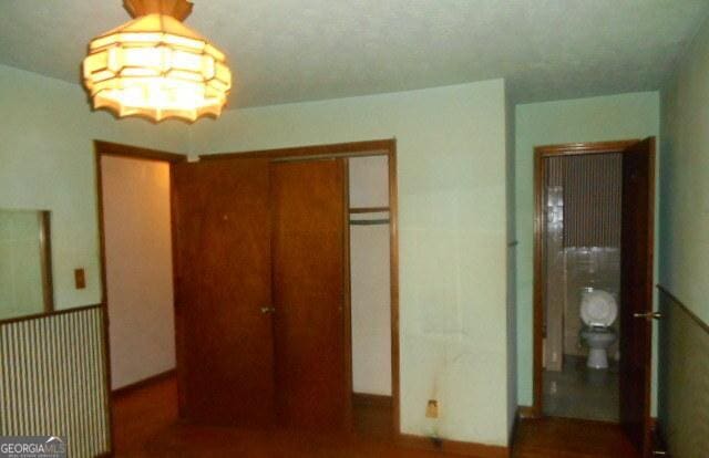 3296 Columbia Woods Dr, Decatur, GA 30032 - unfurnished bedroom featuring a closet and a chandelier