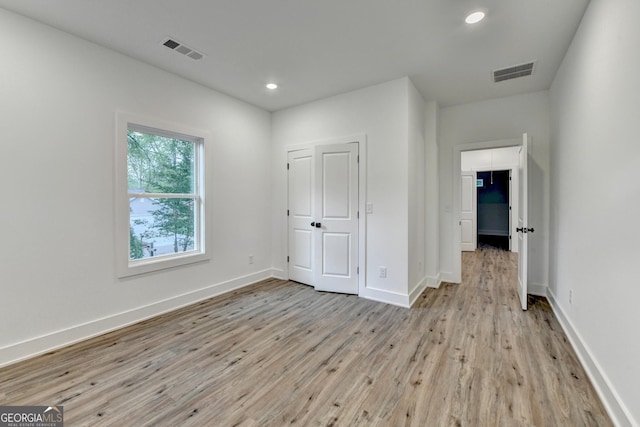 unfurnished bedroom with recessed lighting, visible vents, light wood-style flooring, and baseboards