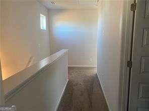 hall featuring baseboards