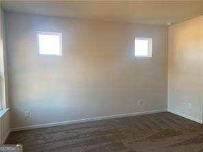 spare room with baseboards