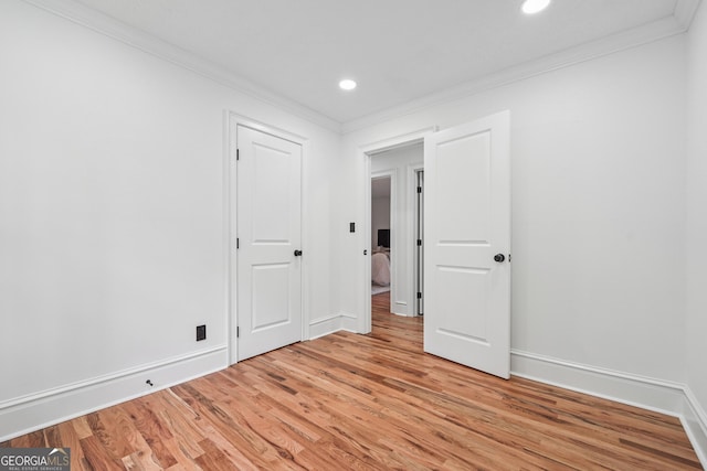 unfurnished bedroom with baseboards, recessed lighting, ornamental molding, and light wood finished floors