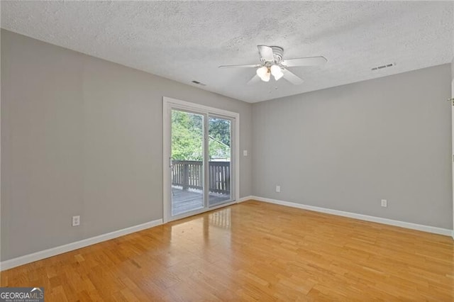 4811 Nevilly Way, Marietta, GA 30066 - unfurnished room with light wood finished floors, a textured ceiling, ceiling fan, and baseboards