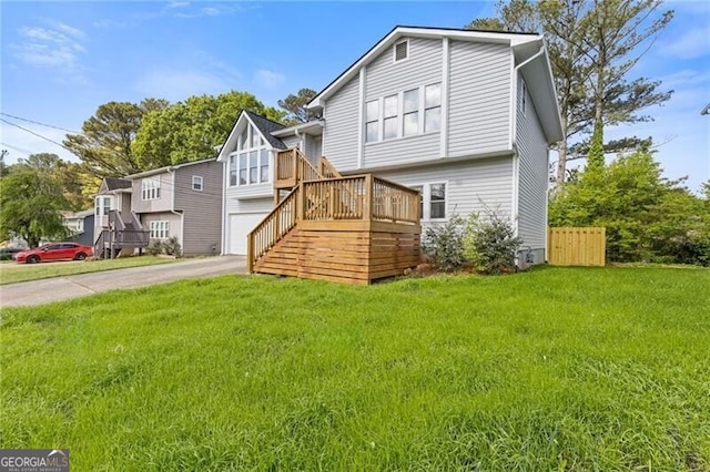 4811 Nevilly Way, Marietta, GA 30066 - rear view of house featuring a lawn, driveway, and stairway