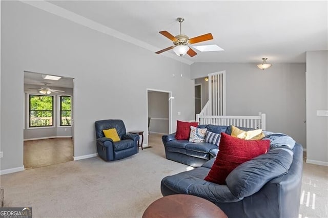 4811 Nevilly Way, Marietta, GA 30066 - carpeted living room with ceiling fan, vaulted ceiling with skylight, and baseboards