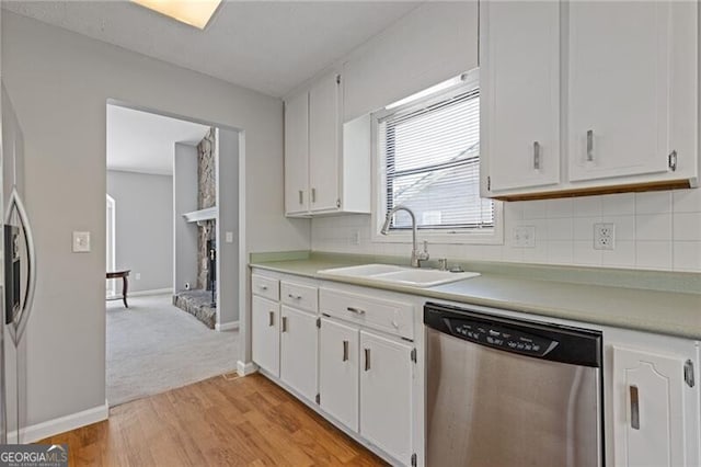 4811 Nevilly Way, Marietta, GA 30066 - kitchen featuring white cabinetry, tasteful backsplash, stainless steel dishwasher, a sink, and light countertops