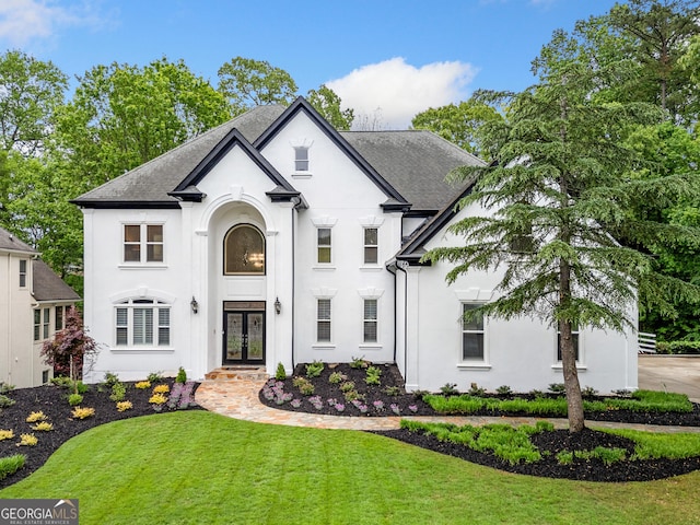 2321 Edgemere Lake Cir, Marietta, GA 30062 - french country home featuring french doors, stucco siding, a shingled roof, and a front yard
