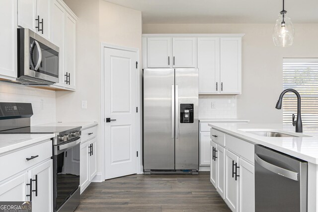432 Cantrell Dr, Dallas, GA 30157 - kitchen with a sink, dark wood-style flooring, decorative backsplash, white cabinets, and appliances with stainless steel finishes