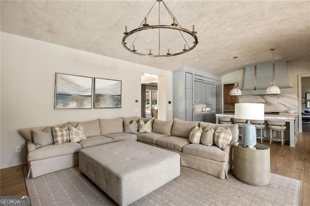 living room with baseboards, lofted ceiling, and hardwood / wood-style flooring
