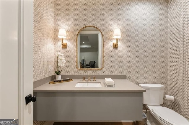 bathroom with toilet and vanity