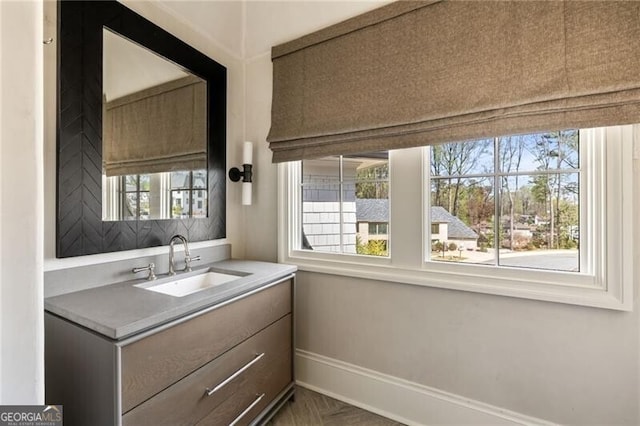 bathroom featuring baseboards and vanity