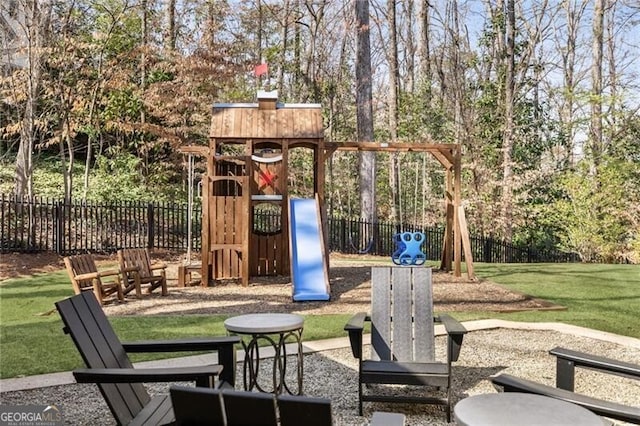 view of play area featuring a lawn and fence
