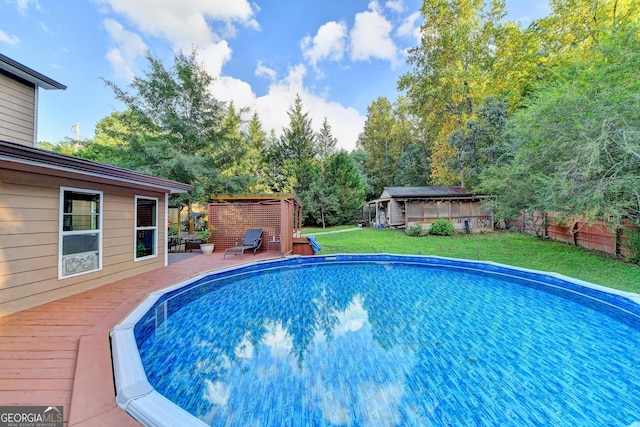 4364 Saddlecreek Ct, Auburn, GA 30011 - view of pool featuring a fenced in pool, a deck, an outbuilding, a lawn, and fence