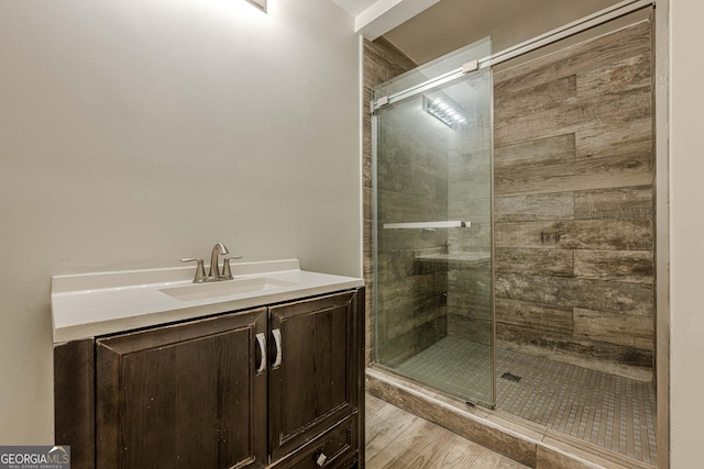 4806 Rockbridge Rd, Stone Mountain, GA 30083 - full bathroom featuring a stall shower, vanity, and wood finished floors