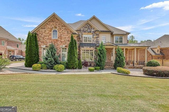 2932 Springbluff Ln, Buford, GA 30519 - view of front of home featuring covered porch, brick siding, and a front lawn