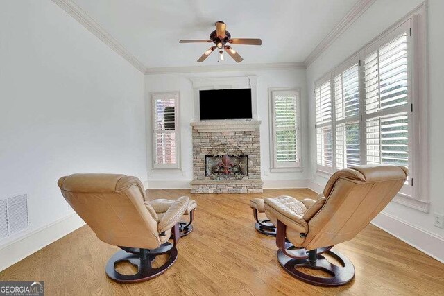 2932 Springbluff Ln, Buford, GA 30519 - living room featuring visible vents, baseboards, a fireplace, wood finished floors, and a ceiling fan