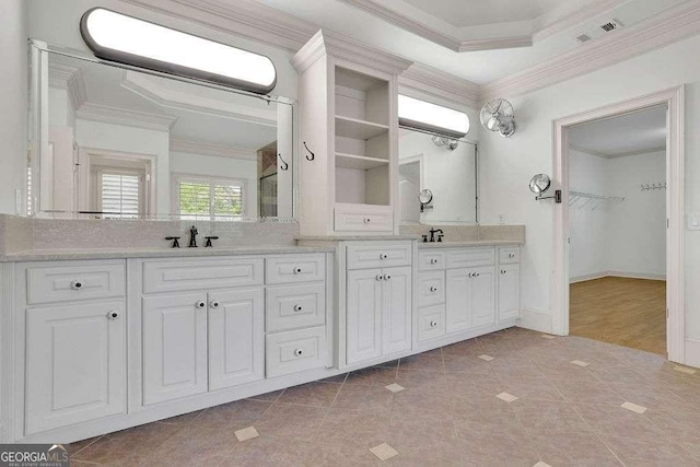 2932 Springbluff Ln, Buford, GA 30519 - bedroom with a tray ceiling, crown molding, a stone fireplace, light wood-style flooring, and baseboards