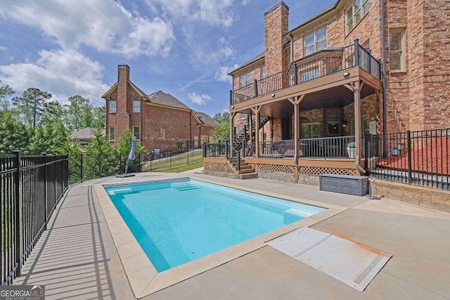 2932 Springbluff Ln, Buford, GA 30519 - view of swimming pool with fence, a patio, a wooden deck, and a fenced in pool