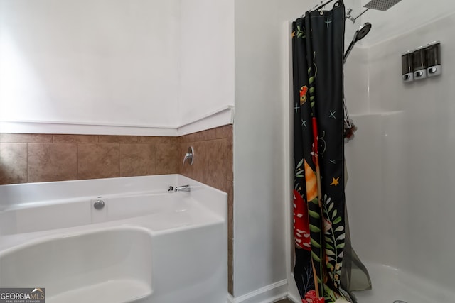 full bathroom featuring a stall shower and a bath