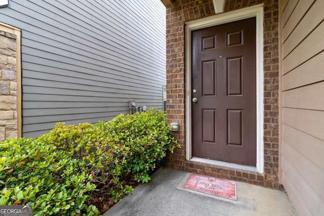 property entrance featuring brick siding