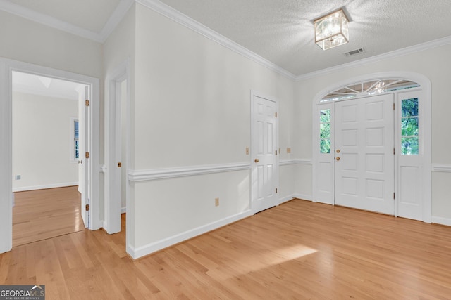 45 Herons Nest, Savannah, GA 31410 - entryway featuring ornamental molding, light wood finished floors, baseboards, visible vents, and a textured ceiling