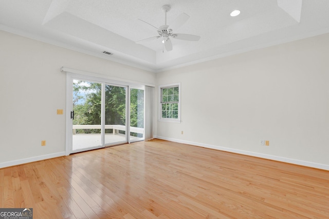 45 Herons Nest, Savannah, GA 31410 - spare room with a ceiling fan, a wealth of natural light, a raised ceiling, and light wood-type flooring