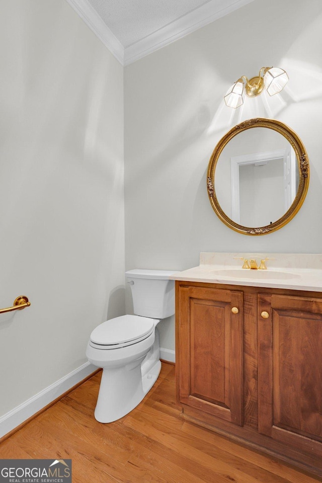 45 Herons Nest, Savannah, GA 31410 - half bathroom featuring crown molding, vanity, toilet, and wood finished floors