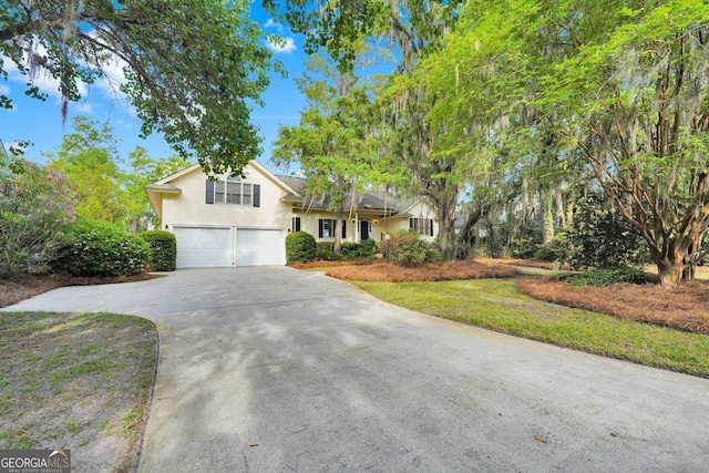45 Herons Nest, Savannah, GA 31410 - tri-level home featuring concrete driveway, an attached garage, and stucco siding