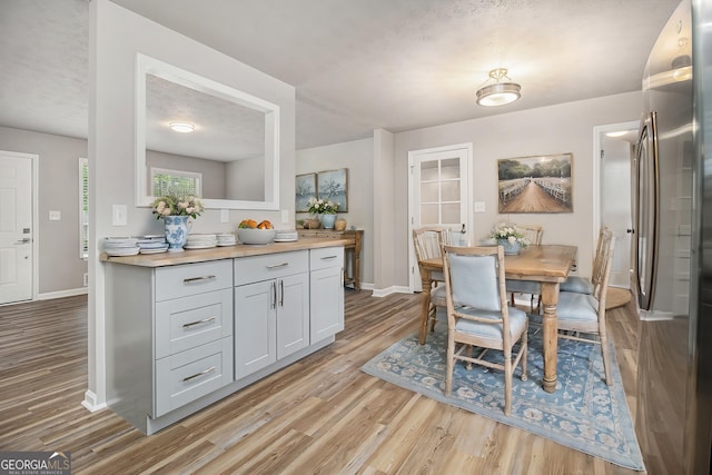 898 Doeskin Dr NW, Conyers, GA 30012 - dining room featuring light wood-style flooring and baseboards