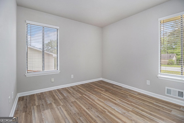 898 Doeskin Dr NW, Conyers, GA 30012 - spare room with wood finished floors and baseboards