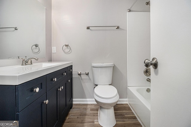 898 Doeskin Dr NW, Conyers, GA 30012 - bathroom featuring toilet, wood finished floors, vanity, bathtub / shower combination, and baseboards