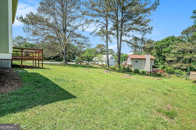898 Doeskin Dr NW, Conyers, GA 30012 - view of green lawn with cooling unit and a deck