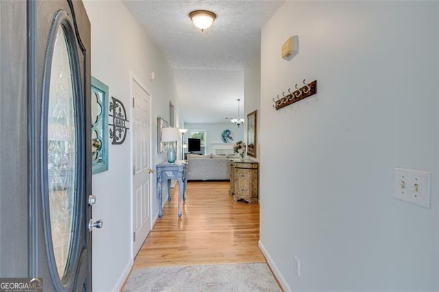 2602 Midler Ct, Buford, GA 30519 - hallway featuring light wood finished floors and a textured ceiling