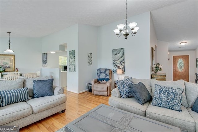 2602 Midler Ct, Buford, GA 30519 - living area with wood finished floors, a chandelier, and lofted ceiling