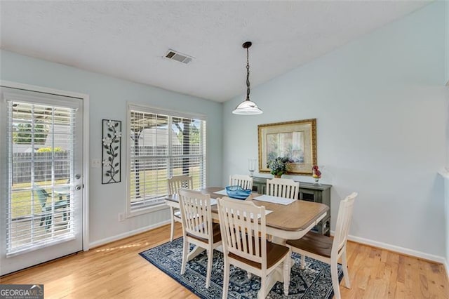 2602 Midler Ct, Buford, GA 30519 - dining room with light wood finished floors, healthy amount of natural light, and vaulted ceiling