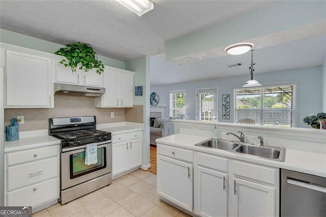 2602 Midler Ct, Buford, GA 30519 - kitchen featuring appliances with stainless steel finishes, under cabinet range hood, white cabinets, and a textured ceiling