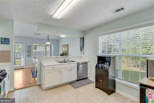 2602 Midler Ct, Buford, GA 30519 - kitchen with dishwasher, a peninsula, white cabinetry, light countertops, and a textured ceiling