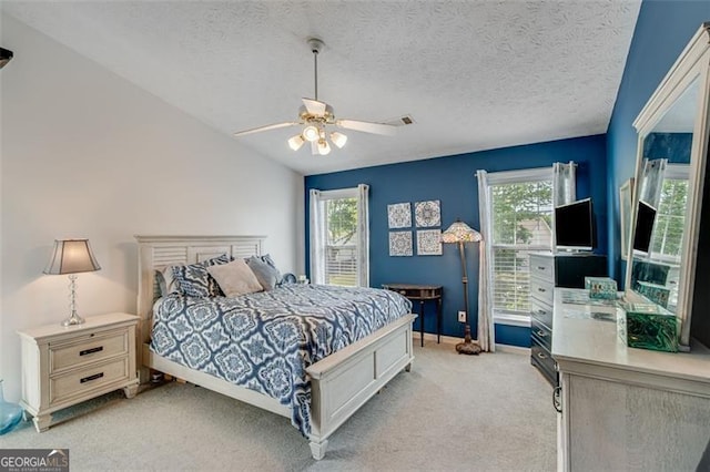 2602 Midler Ct, Buford, GA 30519 - bedroom with multiple windows, light carpet, a ceiling fan, and a textured ceiling
