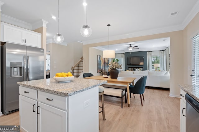 1027 Victoria Heights Dr, Dallas, GA 30132 - kitchen with stainless steel appliances, crown molding, ceiling fan, a kitchen breakfast bar, and light wood finished floors