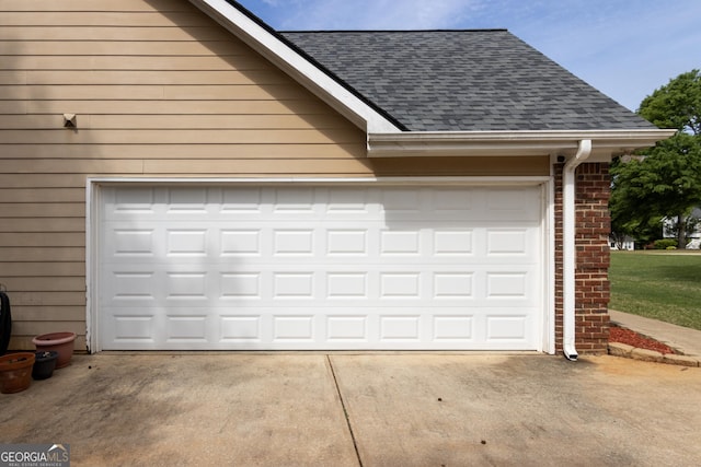 garage featuring concrete driveway