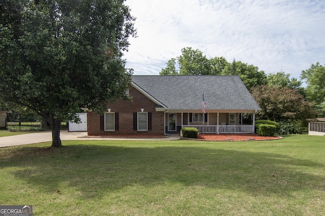 view of front of house with a porch, brick siding, a shingled roof, driveway, and a front lawn