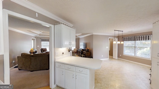 kitchen featuring ornamental molding, white cabinetry, open floor plan, and light countertops