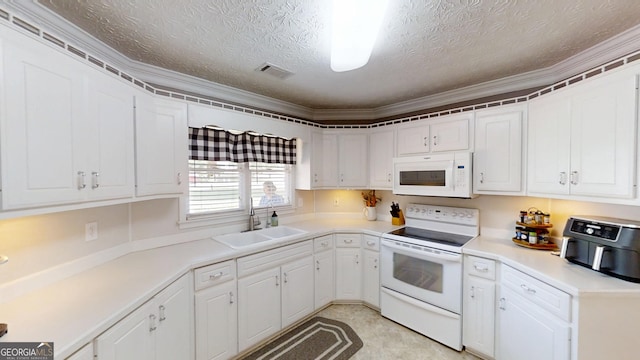 kitchen featuring white appliances, a sink, white cabinetry, visible vents, and a textured ceiling