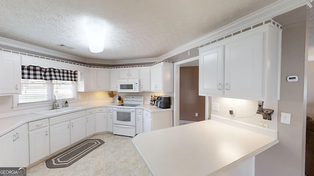 kitchen with white appliances, a peninsula, white cabinets, a sink, and a textured ceiling