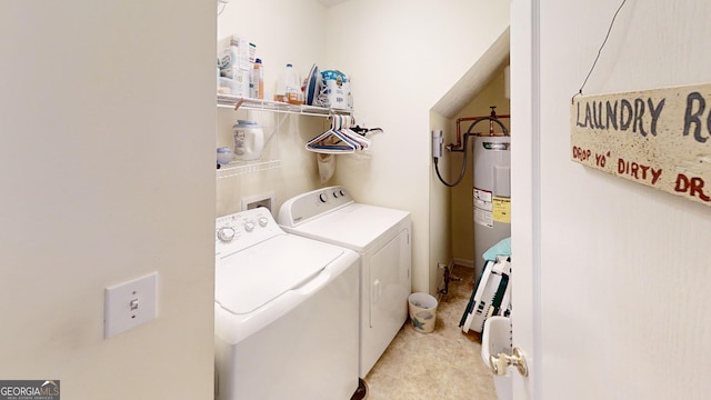 laundry room with water heater, washing machine and clothes dryer, and laundry area