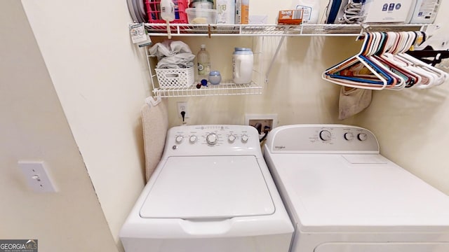 clothes washing area with separate washer and dryer