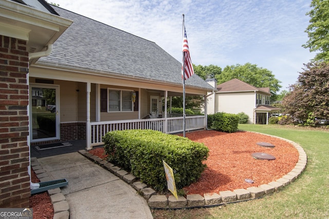 view of yard with covered porch