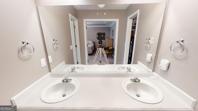 full bathroom featuring double vanity and a sink
