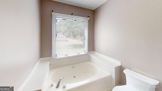 full bath featuring a wealth of natural light, toilet, and a bath