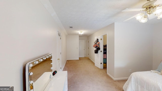 interior space with baseboards, visible vents, light carpet, and a textured ceiling